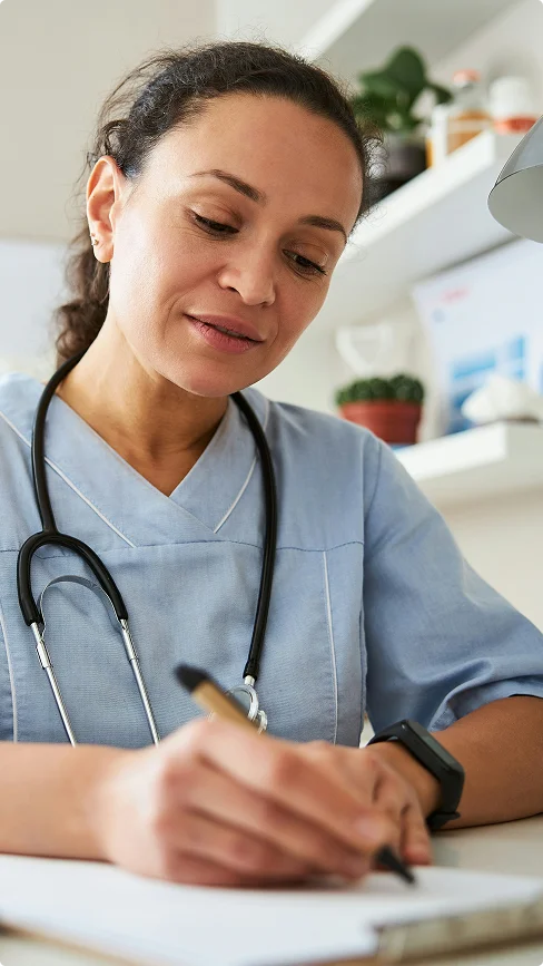 A healthcare professional reviewing notes